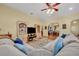 This living room boasts a ceiling fan, hardwood floors, and a huge comfortable sectional couch at 30342 Vitex Ave, Eustis, FL 32736