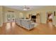 Open-concept living room with hardwood floors, natural light, and access to outdoor patio at 30342 Vitex Ave, Eustis, FL 32736