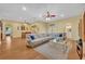 Comfortable sectional couch sits in a spacious living room with hardwood floors and yellow walls at 30342 Vitex Ave, Eustis, FL 32736