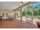 Enclosed patio area with ceiling fans, tile flooring, table, and chairs at 30342 Vitex Ave, Eustis, FL 32736