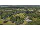 Expansive aerial view of a property with mature trees and a blue border highlighting the land at 31136 Senese Rd, Sorrento, FL 32776
