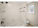 Bathroom with white tiled shower, window, and standard toilet at 31136 Senese Rd, Sorrento, FL 32776