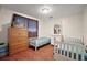 Bedroom with two beds, wooden floors, and ample storage space at 31136 Senese Rd, Sorrento, FL 32776