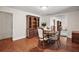 Dining room features wood floors, a round table, and a decorative hutch at 31136 Senese Rd, Sorrento, FL 32776