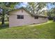 Exterior shot of home with a well-maintained lawn, showcasing a serene, private yard at 31136 Senese Rd, Sorrento, FL 32776