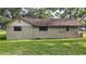 Exterior shot of home with well-maintained lawn, features windows and serene, private yard at 31136 Senese Rd, Sorrento, FL 32776