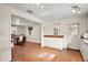 Bright kitchen featuring wood floors, white cabinets, and an adjacent dining area at 31136 Senese Rd, Sorrento, FL 32776