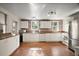 Spacious kitchen featuring white cabinetry, stainless steel appliances, and updated finishes at 31136 Senese Rd, Sorrento, FL 32776