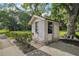 This property includes a charming outbuilding that provides extra space, next to large shade tree at 31136 Senese Rd, Sorrento, FL 32776