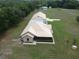 Aerial shot of home with metal roof, expansive lawn, and screened patio at 3147 Rambler Ave, St Cloud, FL 34772