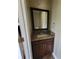 Bathroom vanity with dark wood cabinet, granite countertop, and square mirror at 3147 Rambler Ave, St Cloud, FL 34772