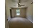 Neutral bedroom with a ceiling fan, plush carpet, closet and a window for natural lighting at 3147 Rambler Ave, St Cloud, FL 34772