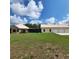 Charming single-story home with a large, green lawn and a detached three-car garage at 3147 Rambler Ave, St Cloud, FL 34772
