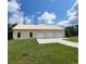Exterior view of a spacious 3-car garage with a concrete driveway and ample parking at 3147 Rambler Ave, St Cloud, FL 34772