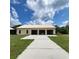 Exterior view of a spacious 3-car garage with a concrete driveway and ample parking at 3147 Rambler Ave, St Cloud, FL 34772