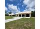 Exterior of the property showcasing a detached three-car garage and long driveway at 3147 Rambler Ave, St Cloud, FL 34772