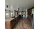 Modern island kitchen flowing seamlessly into the living and dining areas at 3147 Rambler Ave, St Cloud, FL 34772