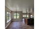 Bright open kitchen and dining space features wood flooring and large windows at 3147 Rambler Ave, St Cloud, FL 34772