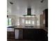 Open kitchen boasts a large island with stainless steel appliances and granite counters at 3147 Rambler Ave, St Cloud, FL 34772