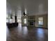 Open-concept living space featuring a stone fireplace and wood-look flooring at 3147 Rambler Ave, St Cloud, FL 34772