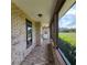 Enclosed porch with brick floors, lots of windows offering views of the grounds and greenery at 3147 Rambler Ave, St Cloud, FL 34772