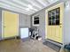 Enclosed back porch with yellow door and deep freezer; some tools and equipment present at 326 N Lancelot Ave, Orlando, FL 32835