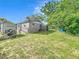 Backyard featuring a shed and a Wolf Pup trailer adjacent to lawn, trees, and fence at 326 N Lancelot Ave, Orlando, FL 32835