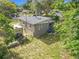 Aerial view of the backyard with shed, Wolf Pup camper, trees, and grass lawn at 326 N Lancelot Ave, Orlando, FL 32835