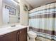 Cozy bathroom with vanity, mirror, decorative wall art and bath/shower with curtain at 326 N Lancelot Ave, Orlando, FL 32835