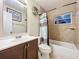 Small bathroom featuring vanity, mirror, toilet, shower/tub and wall decor at 326 N Lancelot Ave, Orlando, FL 32835