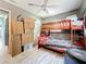 Bedroom featuring bunk beds, wood-look floors, and a ceiling fan; some boxes present in the room at 326 N Lancelot Ave, Orlando, FL 32835