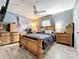 Bedroom features a wooden bed set, a ceiling fan and wood-look flooring and neutral paint at 326 N Lancelot Ave, Orlando, FL 32835