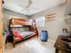 Bedroom with wooden bunk beds, ceiling fan, wood-look floors, and natural light from two windows at 326 N Lancelot Ave, Orlando, FL 32835