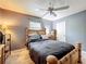 Neutral painted bedroom with wood bed set, ceiling fan and natural light at 326 N Lancelot Ave, Orlando, FL 32835