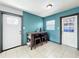 Cozy dining area featuring a table with stools, tile flooring, and stylish blue accent wall at 326 N Lancelot Ave, Orlando, FL 32835