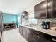 Well lit kitchen with stainless steel sink, speckled granite counter tops, and mosaic backsplash at 326 N Lancelot Ave, Orlando, FL 32835