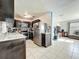 Bright kitchen featuring a stainless steel refrigerator and appliances open to the living room at 326 N Lancelot Ave, Orlando, FL 32835