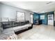 Comfortable living room features a large sofa, tile flooring, and soothing wall colors at 326 N Lancelot Ave, Orlando, FL 32835