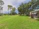 Expansive backyard view showing lawn, trees, and the side of the home at 32701 Timberwood, Leesburg, FL 34748