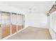 Bright bedroom featuring carpet, ceiling fan, and glass sliding door at 32701 Timberwood, Leesburg, FL 34748