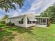 Exterior view of home highlighting the side profile, screened in lanai, and awnings at 32701 Timberwood, Leesburg, FL 34748