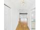 Inviting hallway featuring gleaming wood floors, a decorative light fixture, and open view to living area at 32701 Timberwood, Leesburg, FL 34748