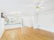 Open-concept living space with hardwood flooring, view of dining area and an adjacent room entrance at 32701 Timberwood, Leesburg, FL 34748