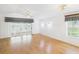 Bright and airy living room with a large glass sliding door, ceiling fan, and stylish window treatments at 32701 Timberwood, Leesburg, FL 34748