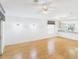 Spacious living area with an open layout, ceiling fan, stylish light fixtures, and a view into the kitchen at 32701 Timberwood, Leesburg, FL 34748