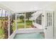 Screened porch with an open view of the lawn and an entry door to the house at 32701 Timberwood, Leesburg, FL 34748