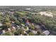 Aerial view of house with pin showing location within a tree-lined neighborhood at 33316 Irongate Dr, Leesburg, FL 34748