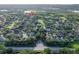 An aerial view showing neighborhood, trees and lake nearby, with location pin on the property at 33316 Irongate Dr, Leesburg, FL 34748
