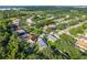 Expansive aerial view of homes in a lush community, near green spaces and the water in the distance at 33316 Irongate Dr, Leesburg, FL 34748