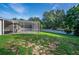 Expansive backyard featuring a screened-in patio, perfect for outdoor entertaining at 33316 Irongate Dr, Leesburg, FL 34748
